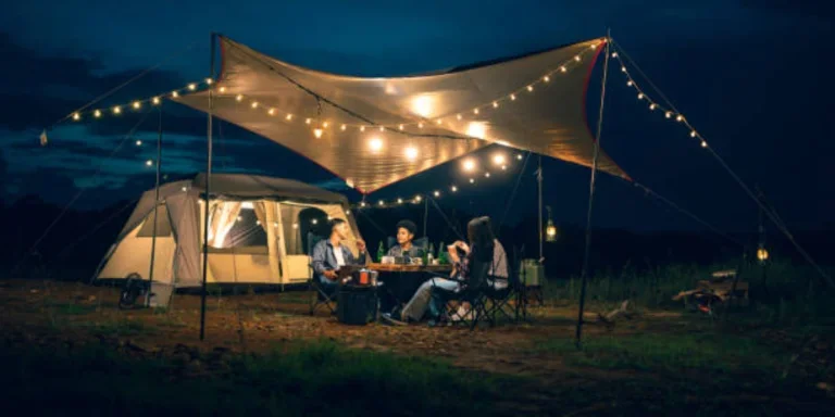 Canopy set up next to tent with LED camping lights