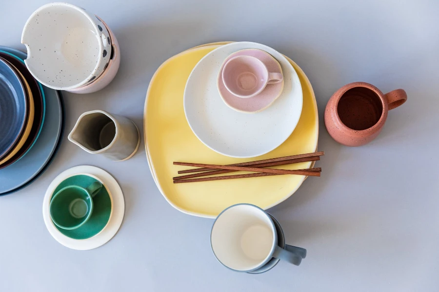 Ceramic teacups with plates and wooden chopsticks