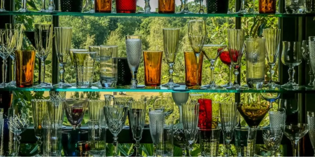 clear drinking glasses on a glass shelf