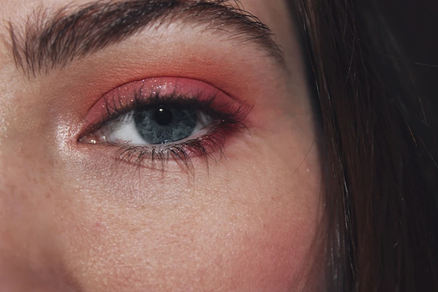 Close-up of a person’s eye wearing pink shimmery eyeshadow