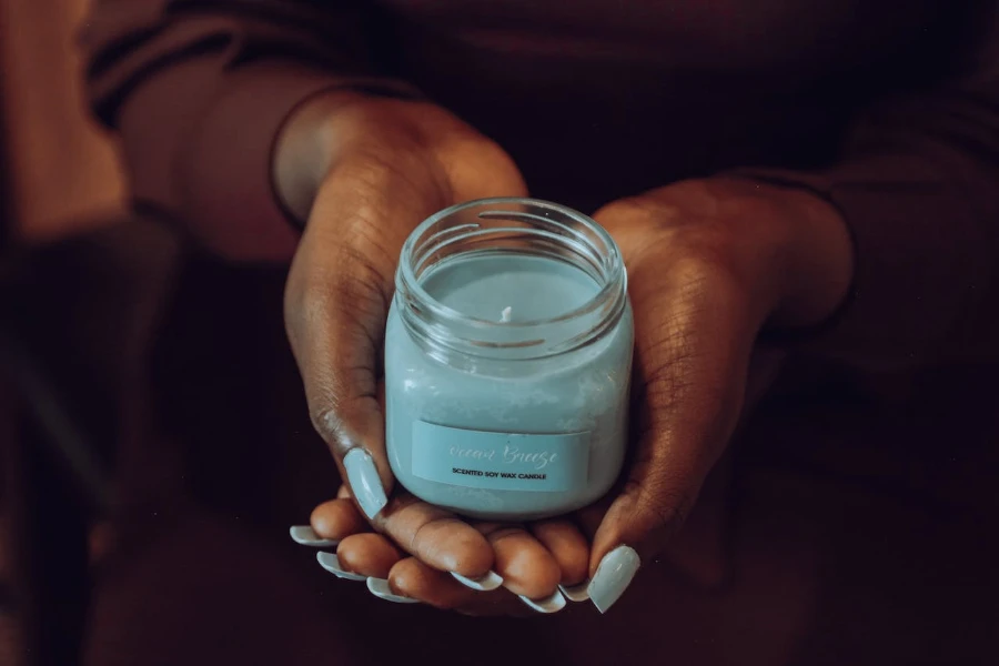 Close-up shot of a person holding a blue candle