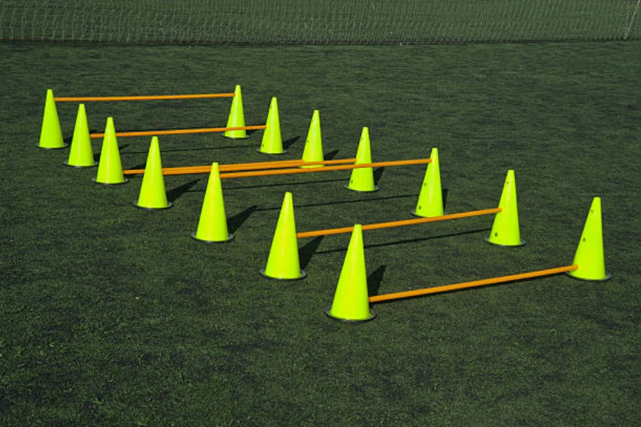 Cone hurdles set up at different heights on grass