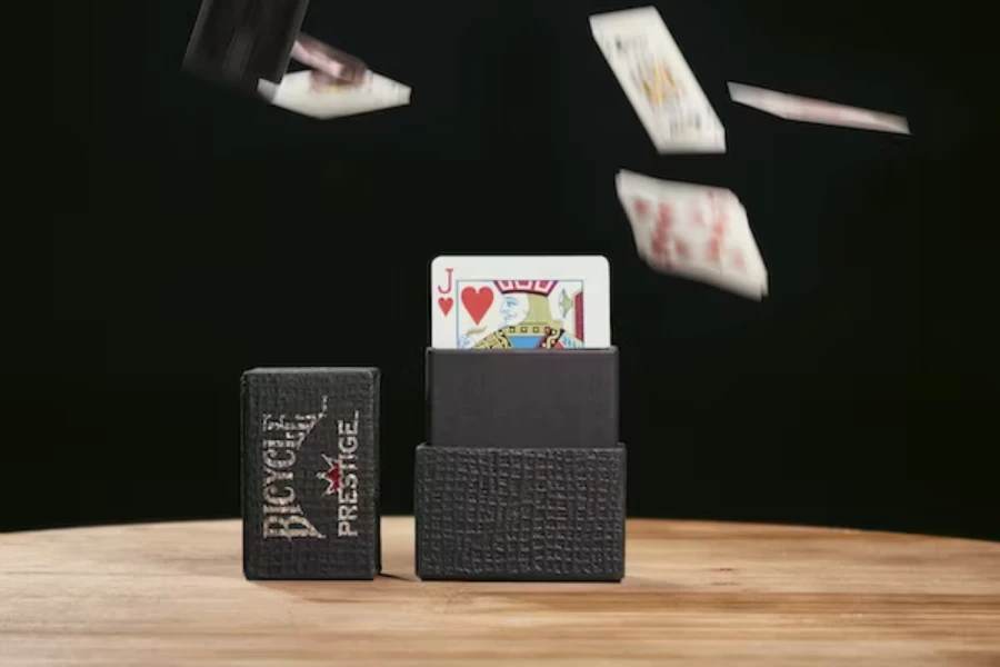 Deck of plastic playing cards sitting in a black cardboard box