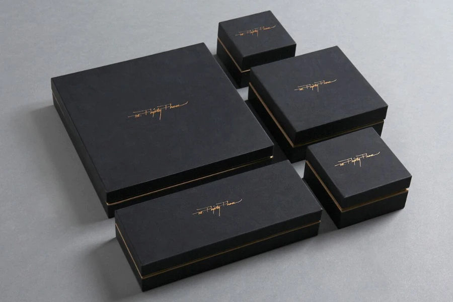 Different black boxes with gold foil-stamped logo