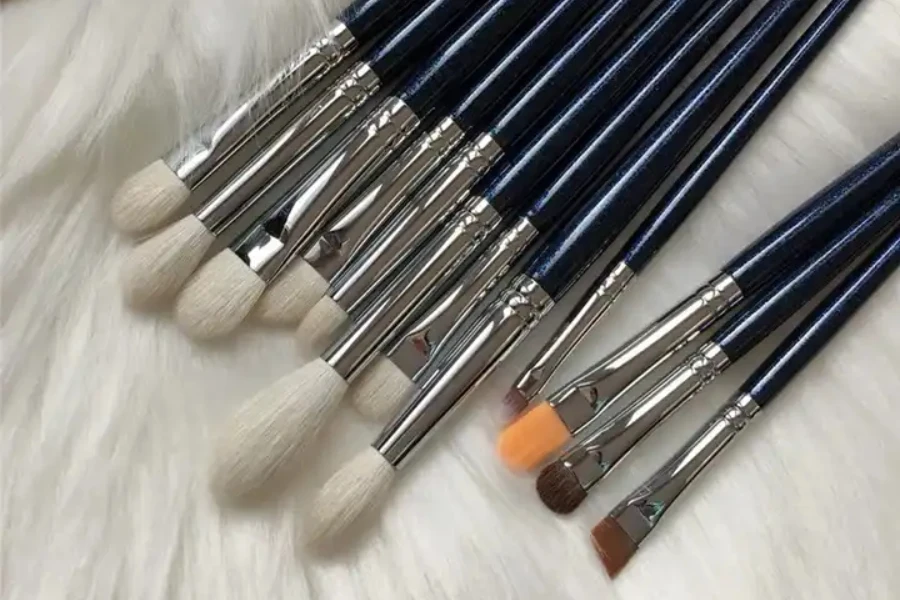 Different eye shadow brushes on a fluffy surface