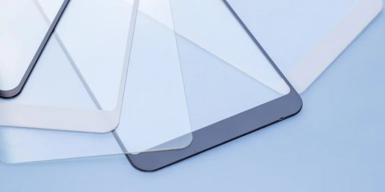 Different types of screen protectors laying on blue background