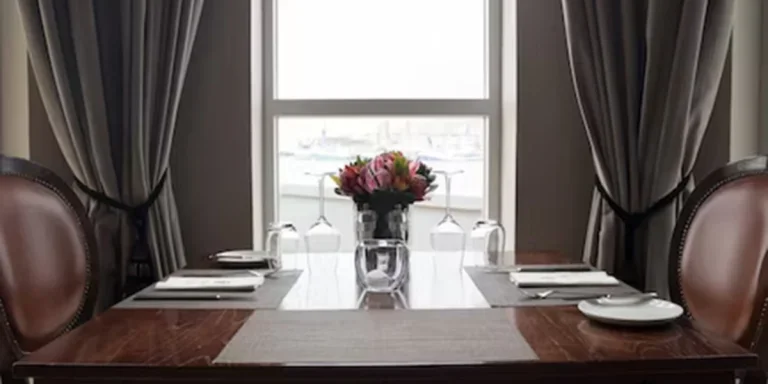 drapes surrounding window with table in the foreground