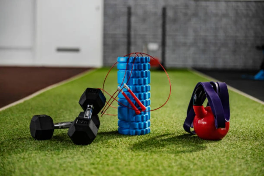 Fitness tools sitting on artificial grass inside a gym