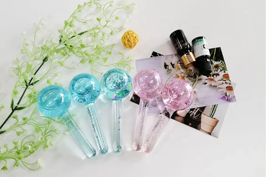 Five ice globes next to some beauty oils