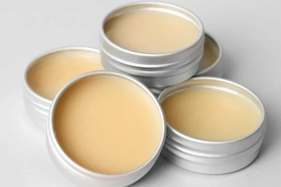 Five silver tins of tattoo balm