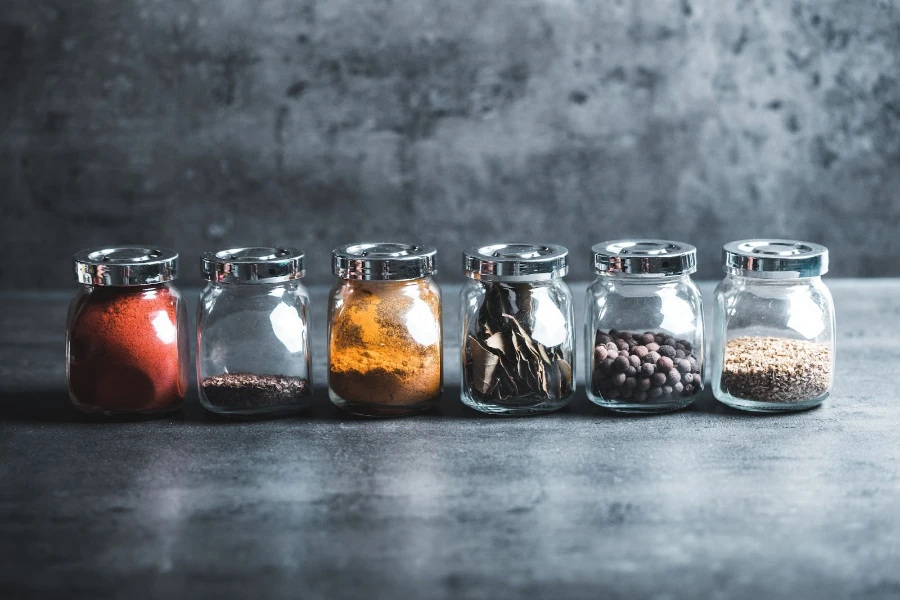 Glass spice jars with spices in them