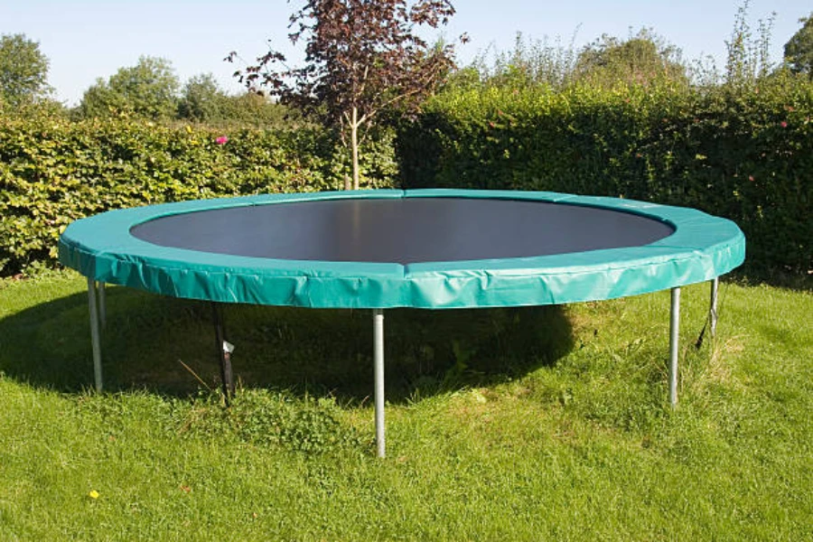Green round trampoline sitting outside the backyard of a house