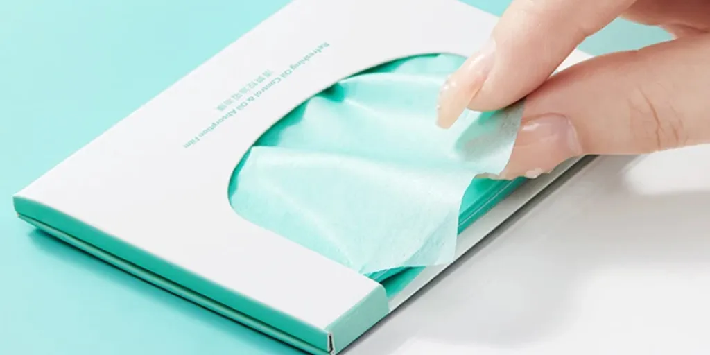 Hand taking a sheet of blotting paper