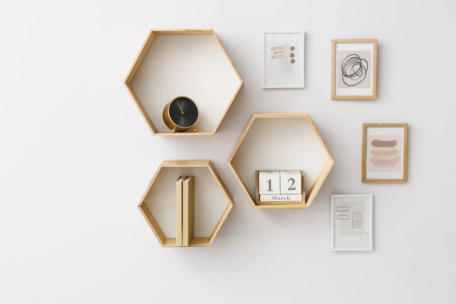 Hexagonal shelves with books and decor hanging on a wall