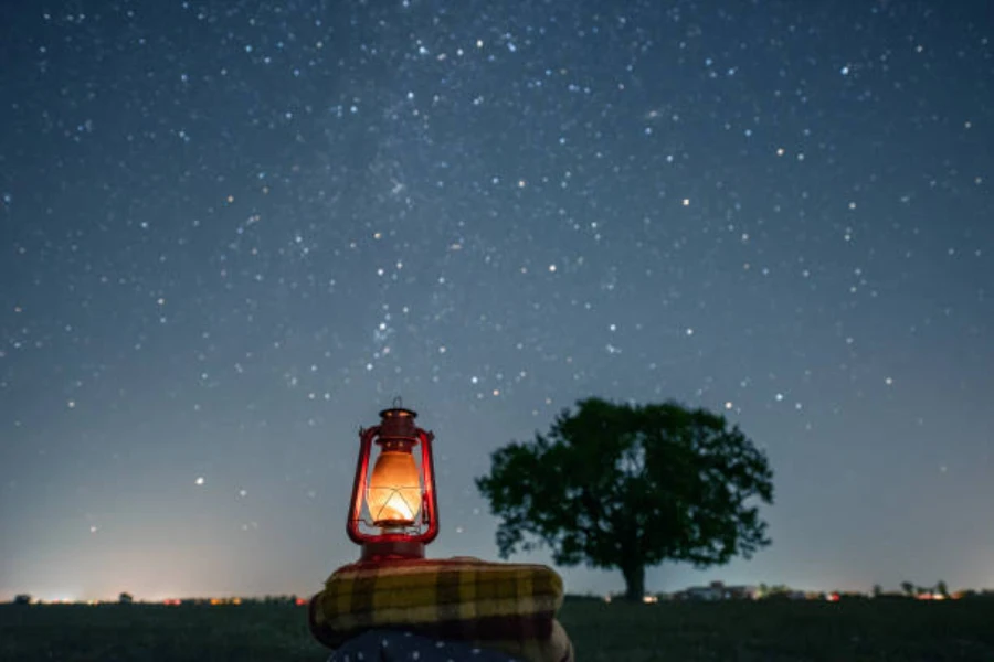 LED camping lantern sitting out under the stars at night