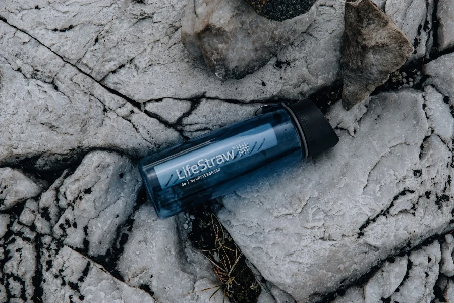 LifeStraw bottle sitting on some rocks