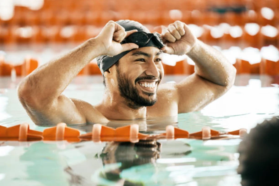 Man wearing a black swimming cap in a pool