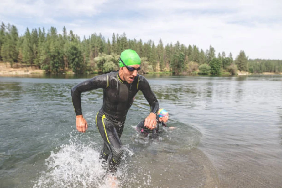 Man wearing green fabric swimming cap in cold water