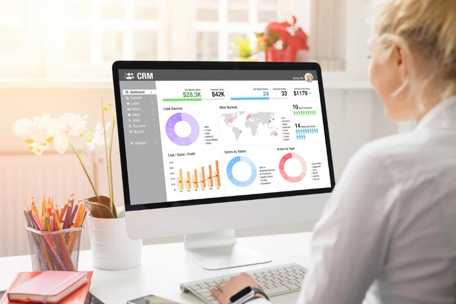 office worker analyzing CRM data on a desktop PC