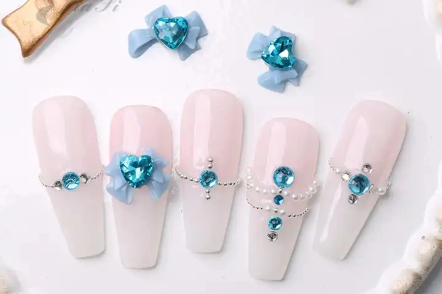 Pastel nails with gems and bows on them