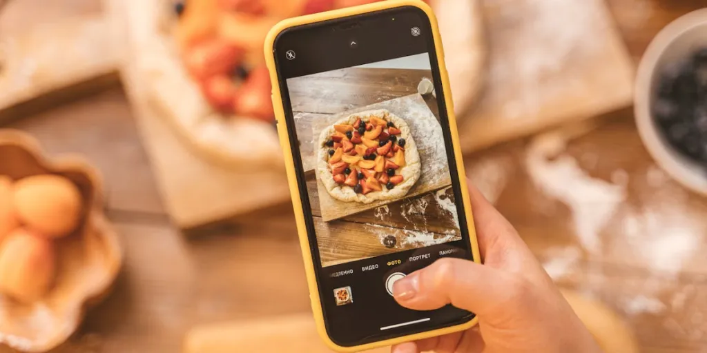 Person taking picture with cellphone of pie