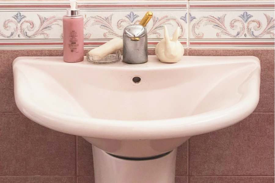 Pink bathroom with pedestal wash basin