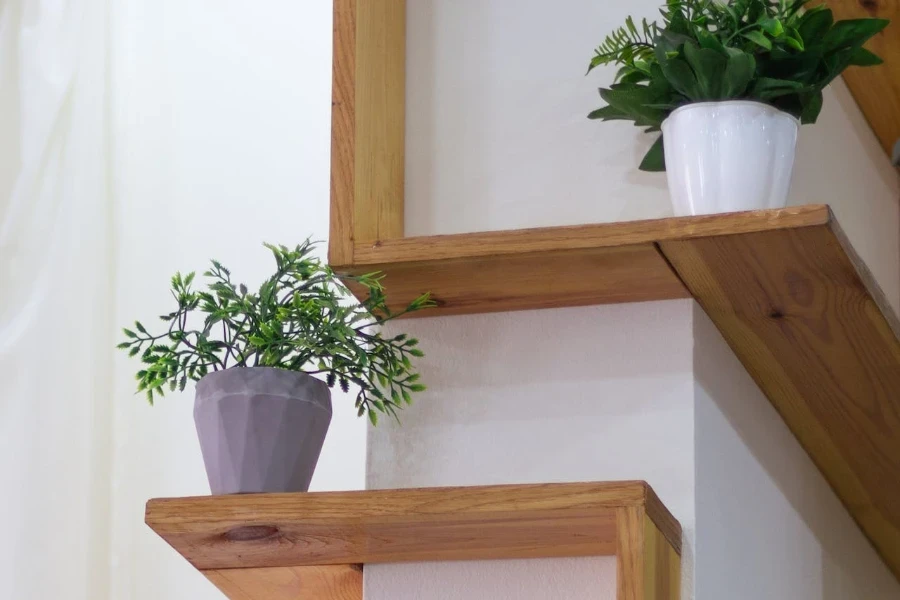 Plants in flowerpots on corner shelves