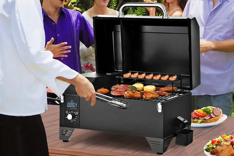 portable electric smoker being used on table in outdoor area
