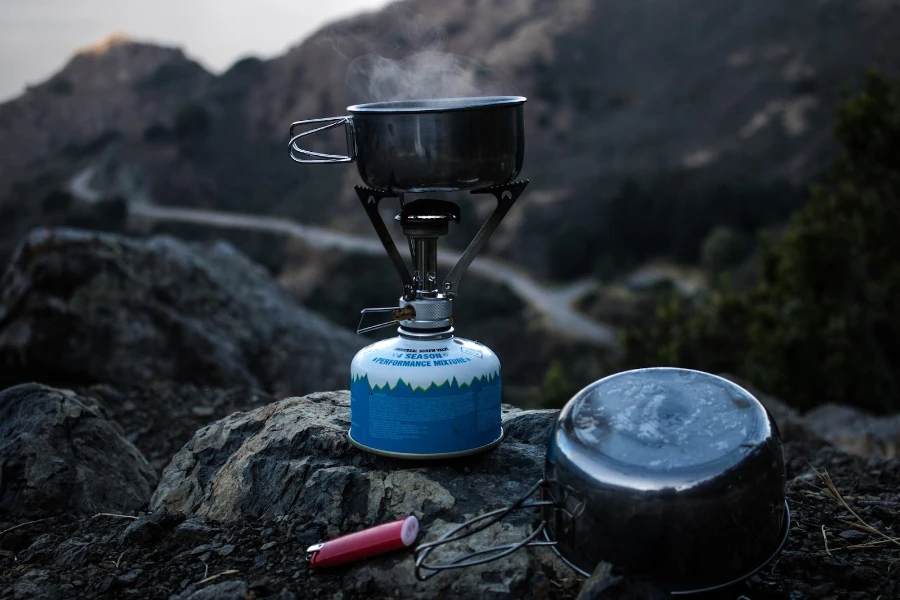 Portable stove heating up a pot on top of a mountain