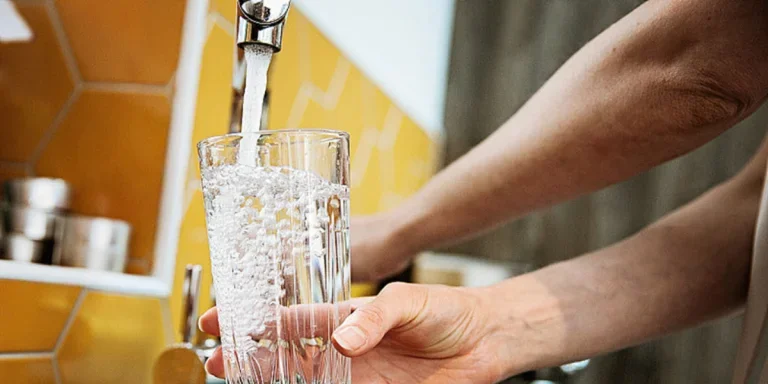 Pouring water from a faucet into a glass