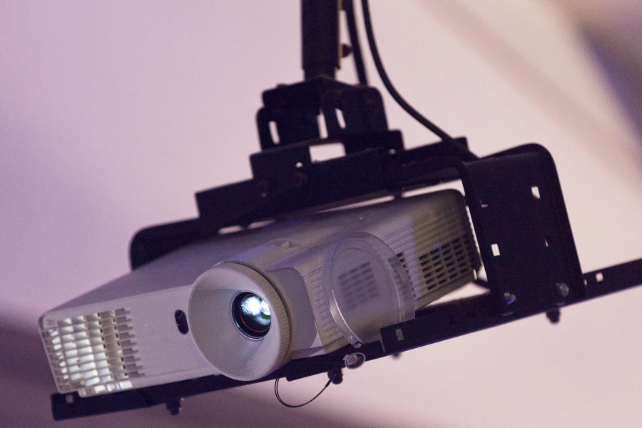 Projector hanging from ceiling mount