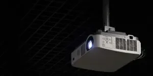 Projector hanging from ceiling mount