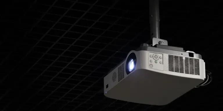 Projector hanging from ceiling mount