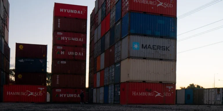 red and blue cargo containers on brown wooden dock