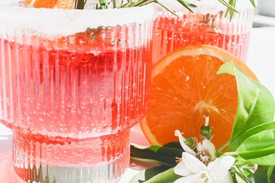red cocktails with fruit served in ribbed drinking glasses
