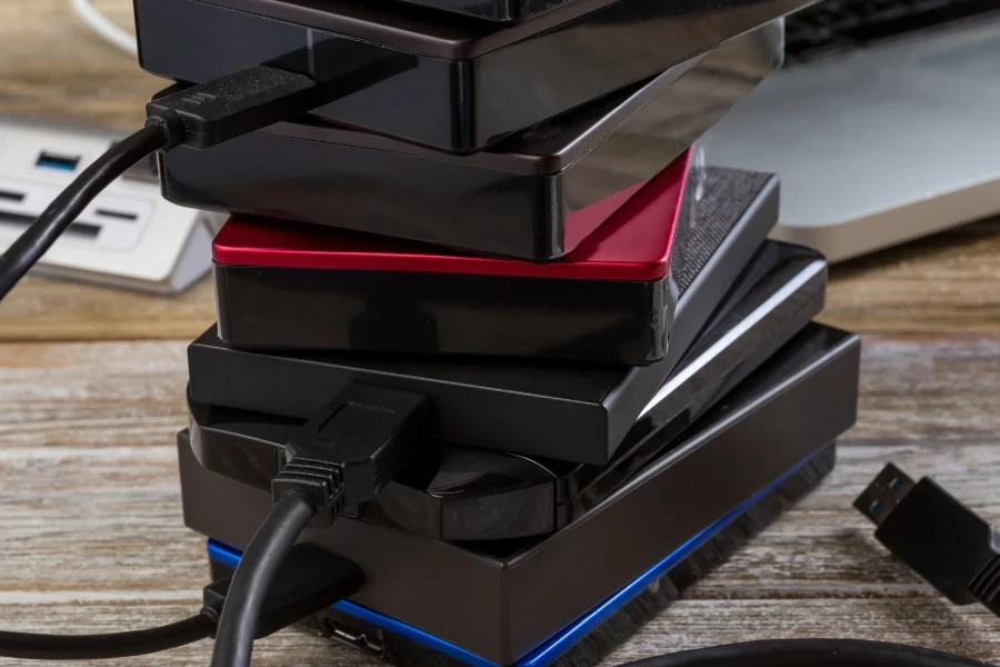 Six stacked hard drives on a wooden table