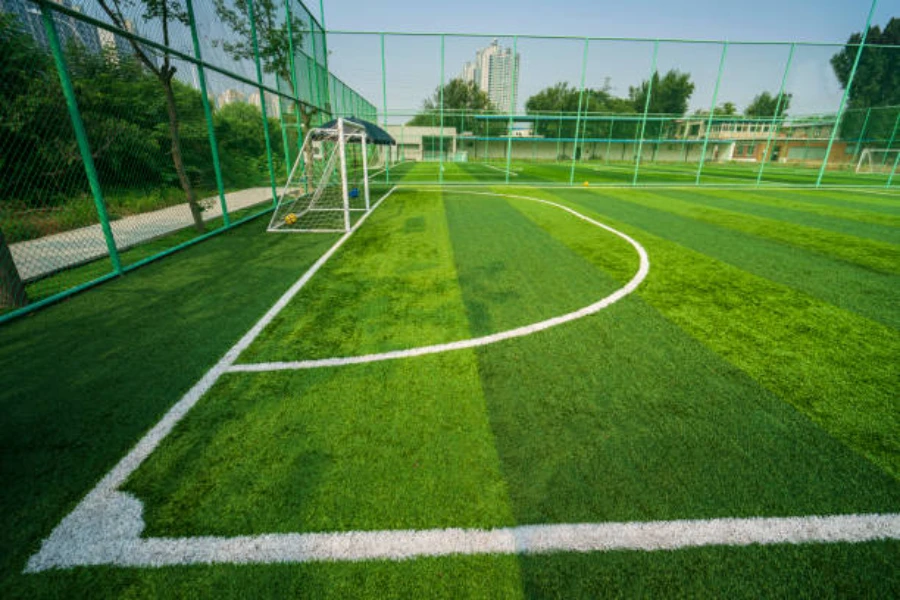 Small enclosed football field with artificial grass installed outdoors