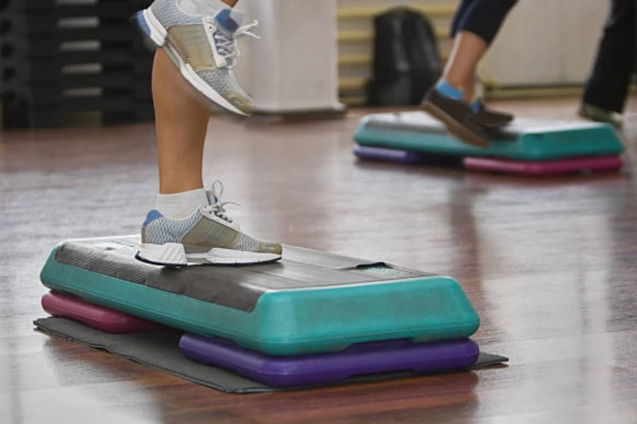 Step exercise platform with height adjusters used in fitness class