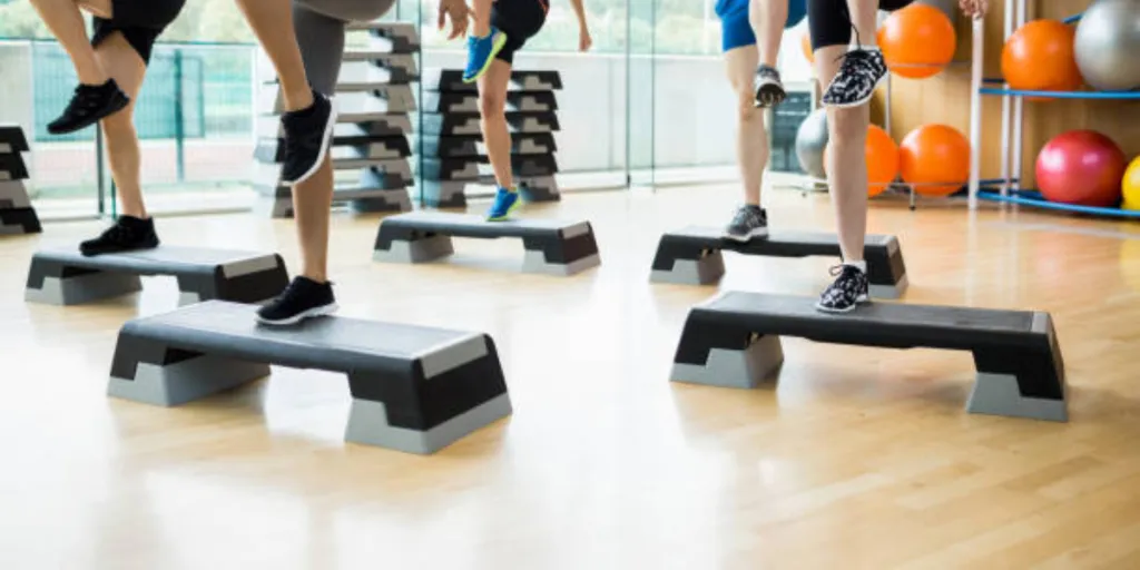 Step exercise platforms being used in gym fitness class