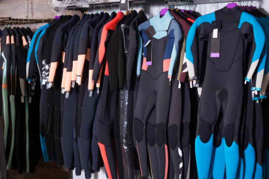 Store with rows of wetsuits hanging from the wall