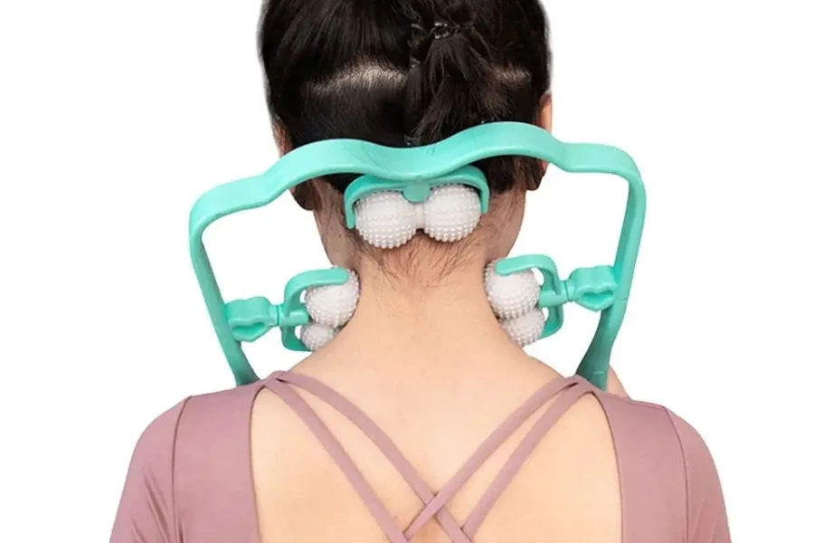 Teal neck roller massager being used by young woman