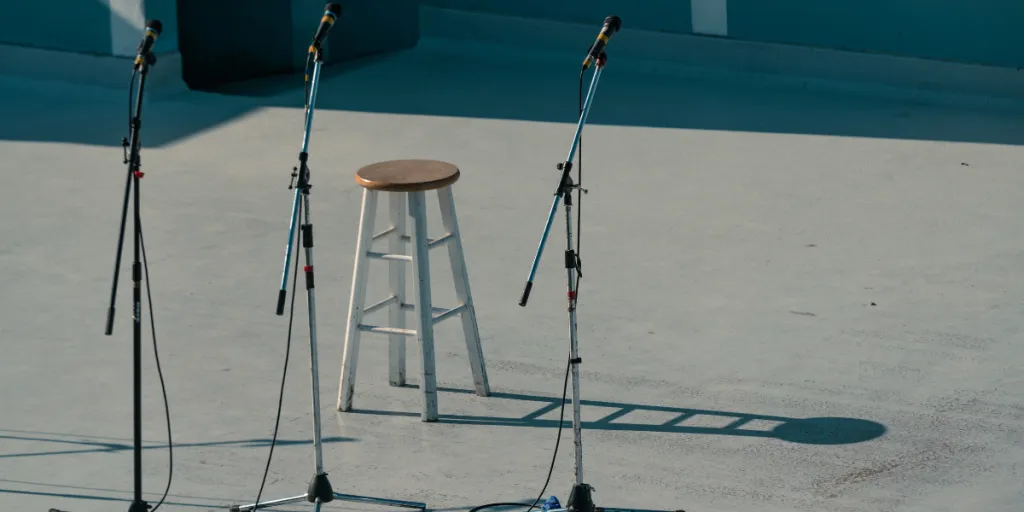 Three microphone stand and a stool on an outdoor stage