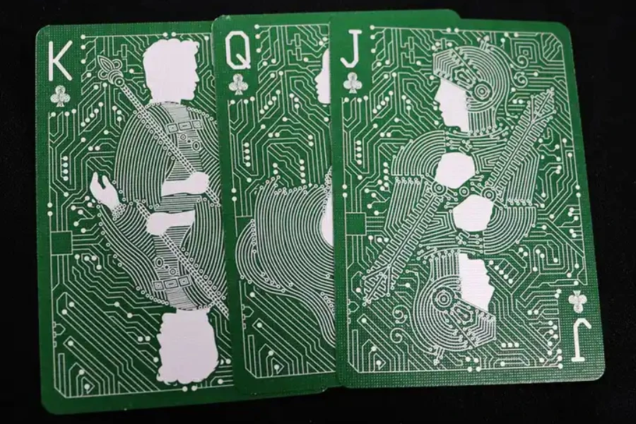 Three themed plastic playing cards with fancy green design