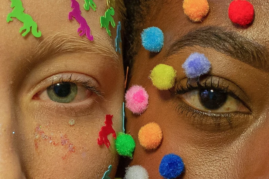 Two women face-to-face with stickers on their faces