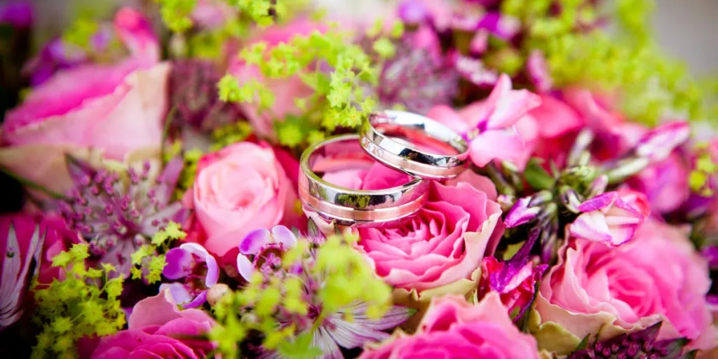 Wedding rings on pink petal flowers
