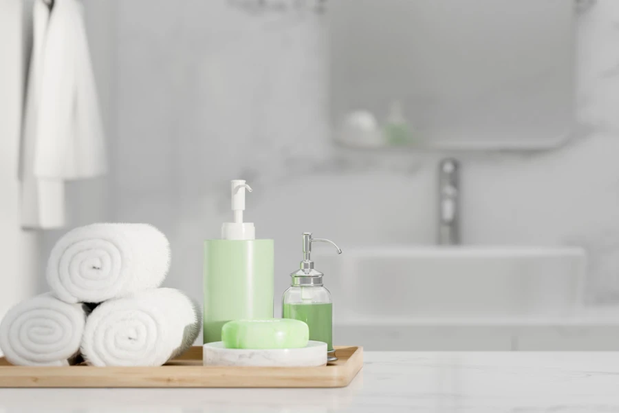 white towels and toiletries in a tray on a bathroom counter
