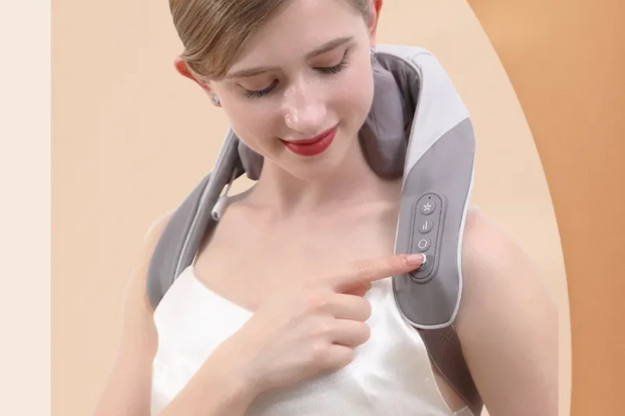 Woman pressing button to control neck and shoulder massager