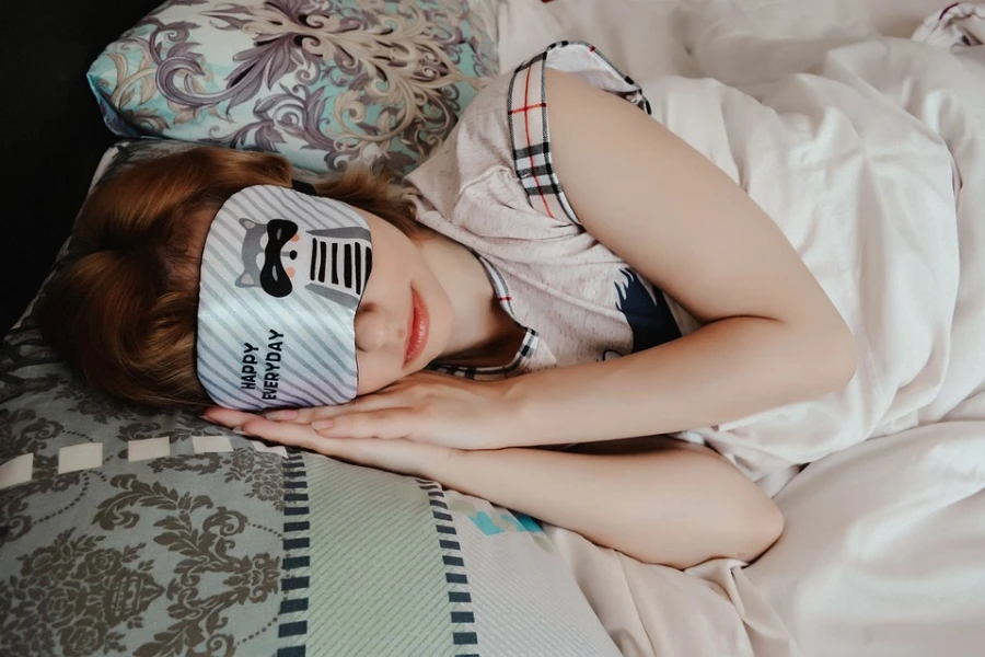 Woman sleeping with a white cloth eye mask