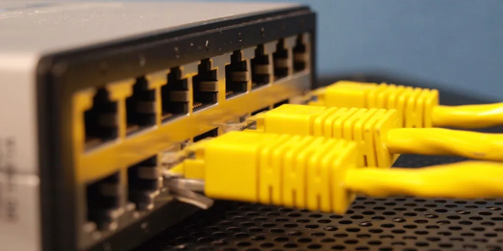 Yellow ethernet cables connected to a networking device