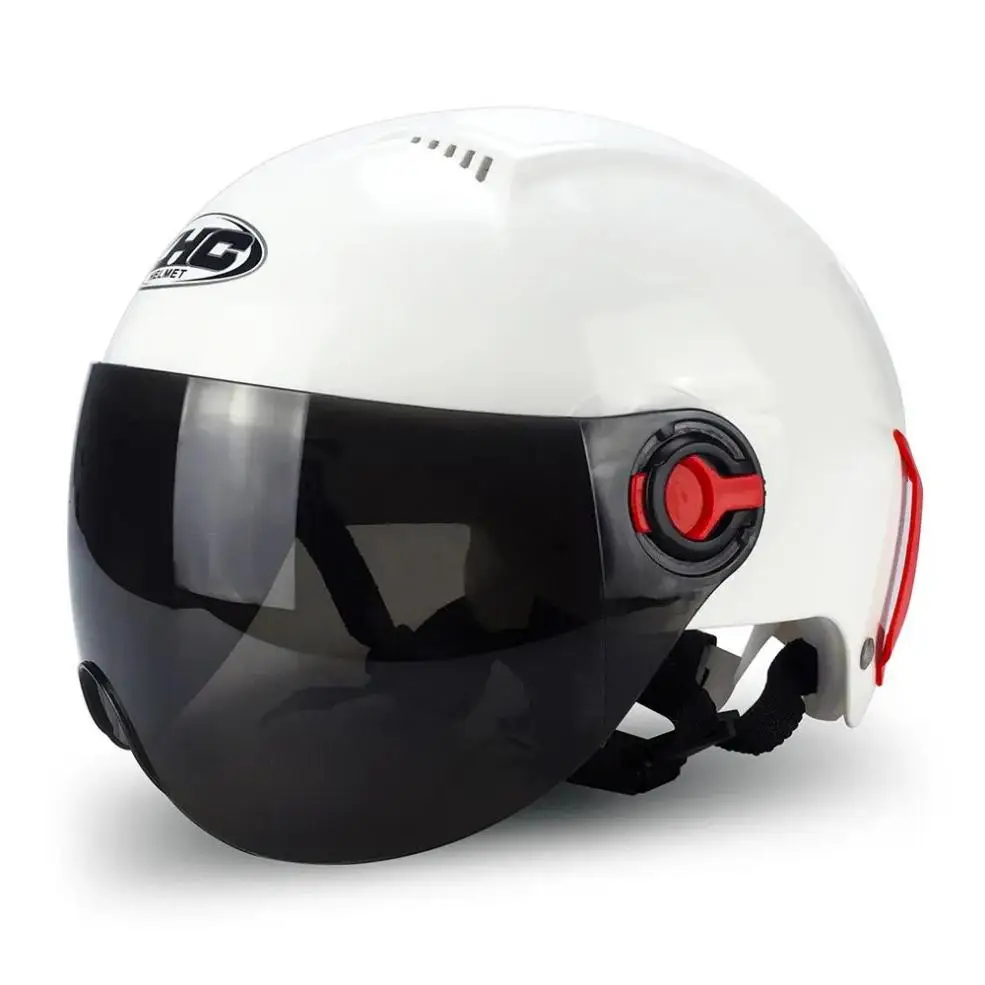 A white motorcycle helmet with an integrated black visor and red adjustment knob